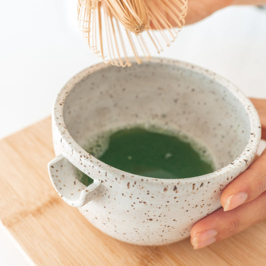Handmade ceramic matcha bowl with pouring spout.